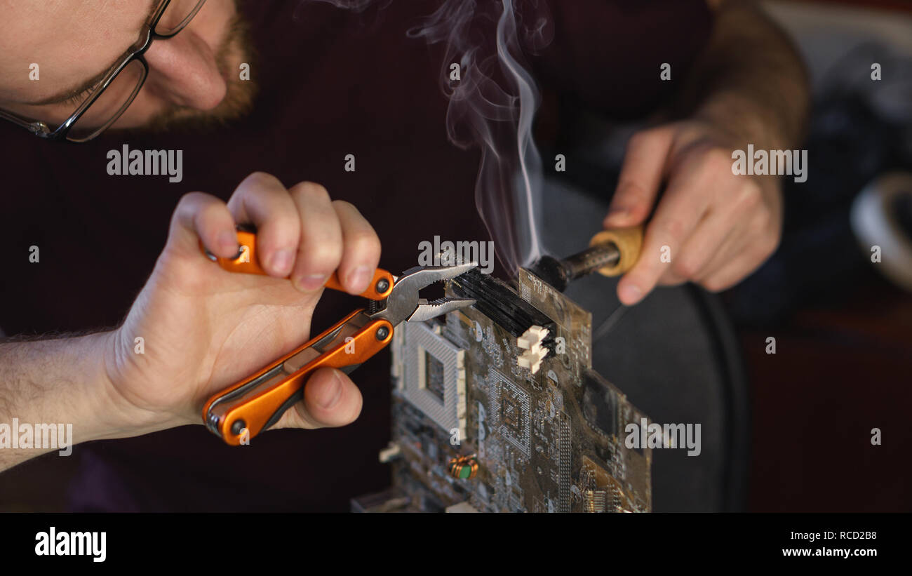 Technician fixing chip on motherboard hi-res stock photography and ...