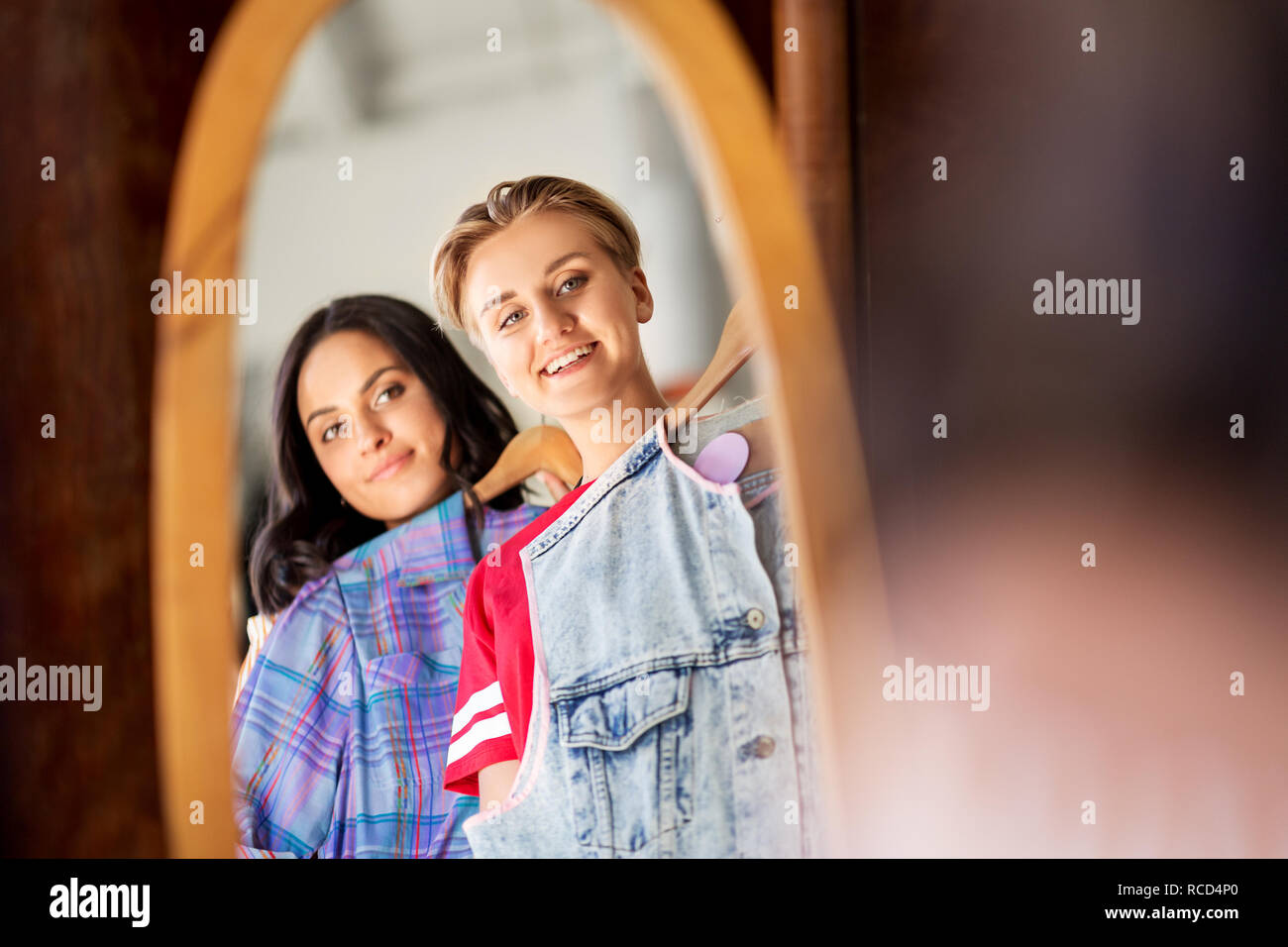 women choosing clothes at vintage clothing store Stock Photo