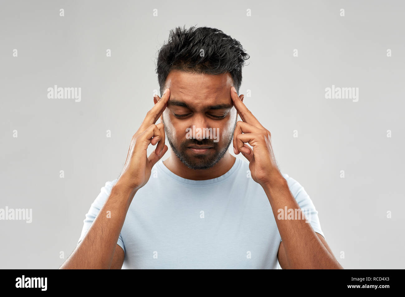 unhappy indian man suffering from headache Stock Photo - Alamy