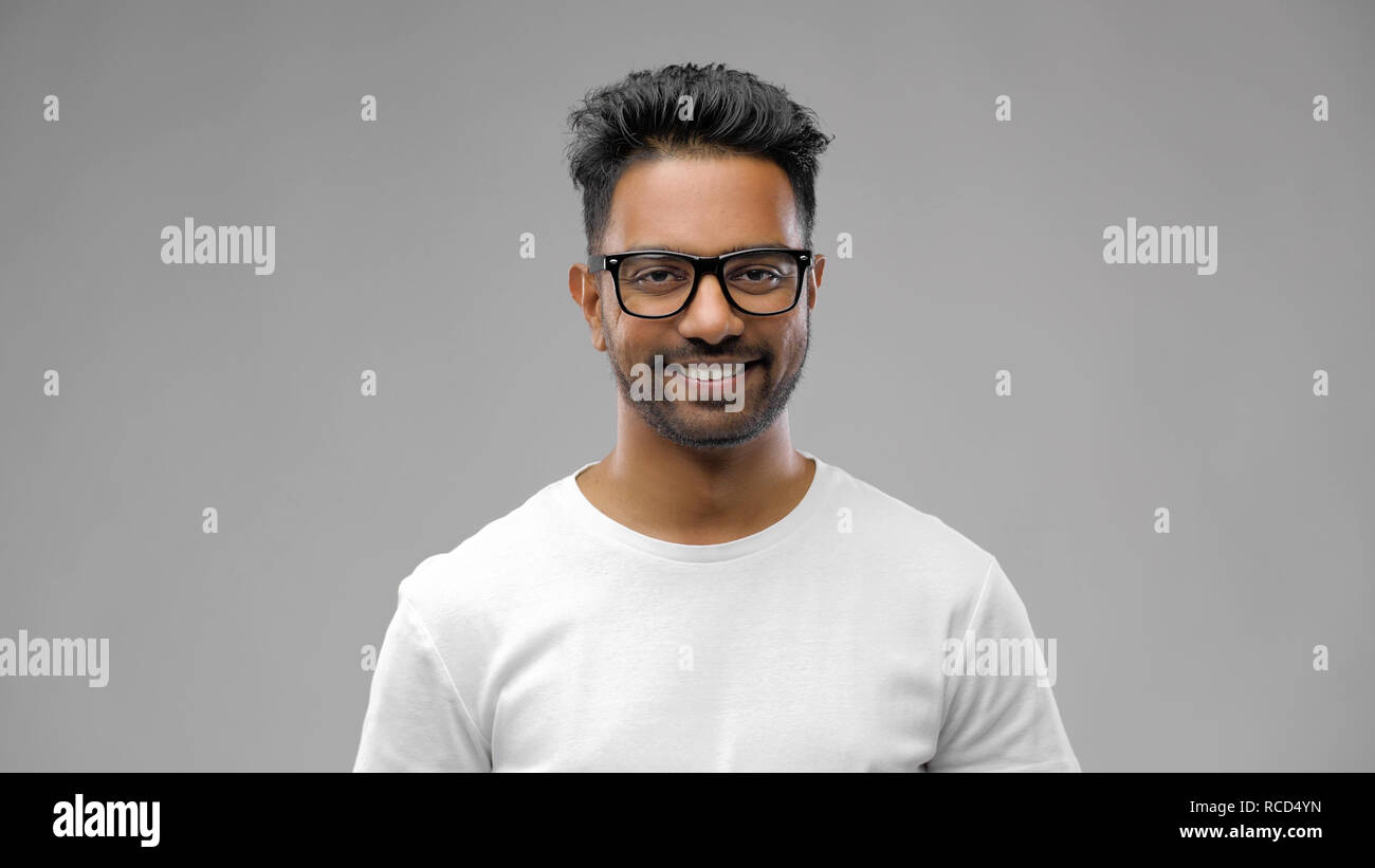 happy indian man in eyeglasses or student Stock Photo