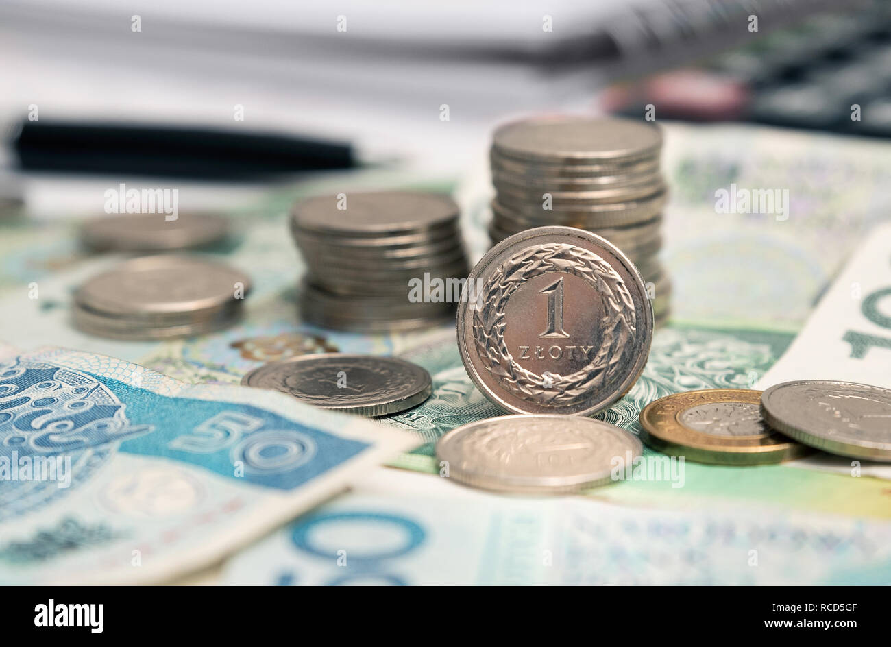 Polish currency, stack of Polish coins. The 1 zloty coin stands in the foreground. Business and financial concept Stock Photo