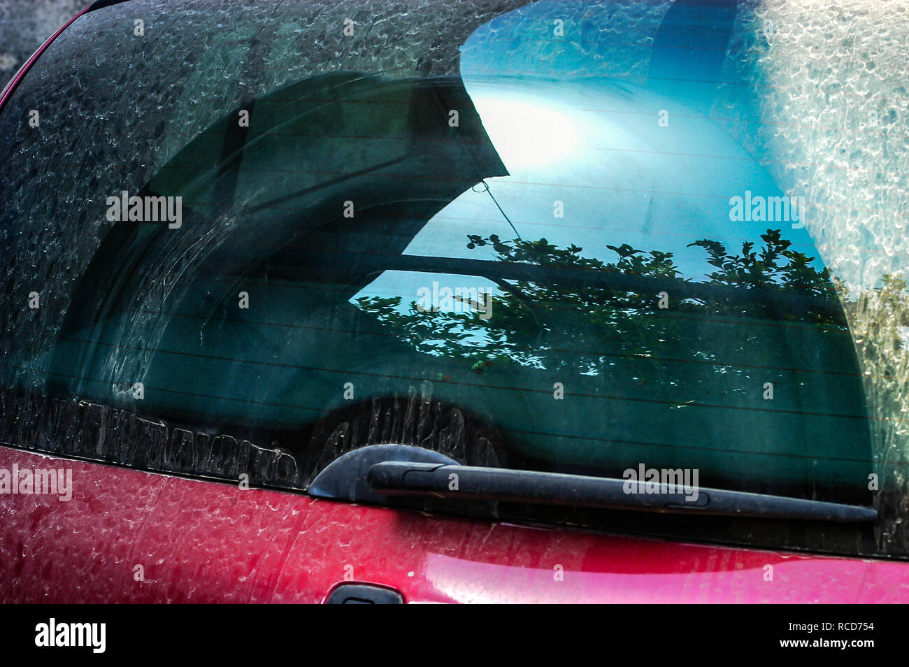 looking at the back window of a very dirty car rear window with wiper