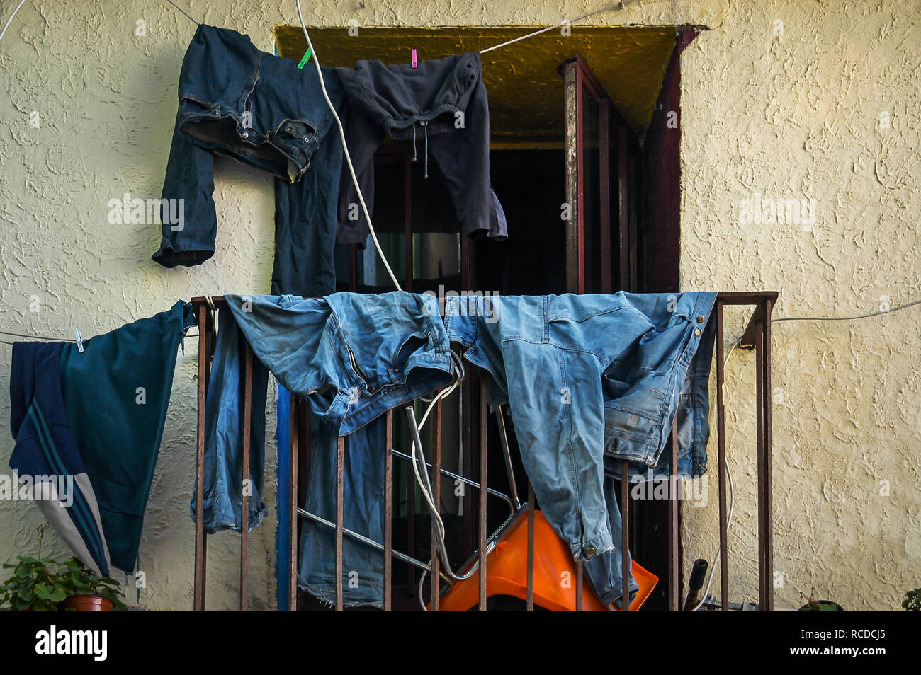 Denim clothes drying in the sun on Balcony Window Stock Photo Alamy