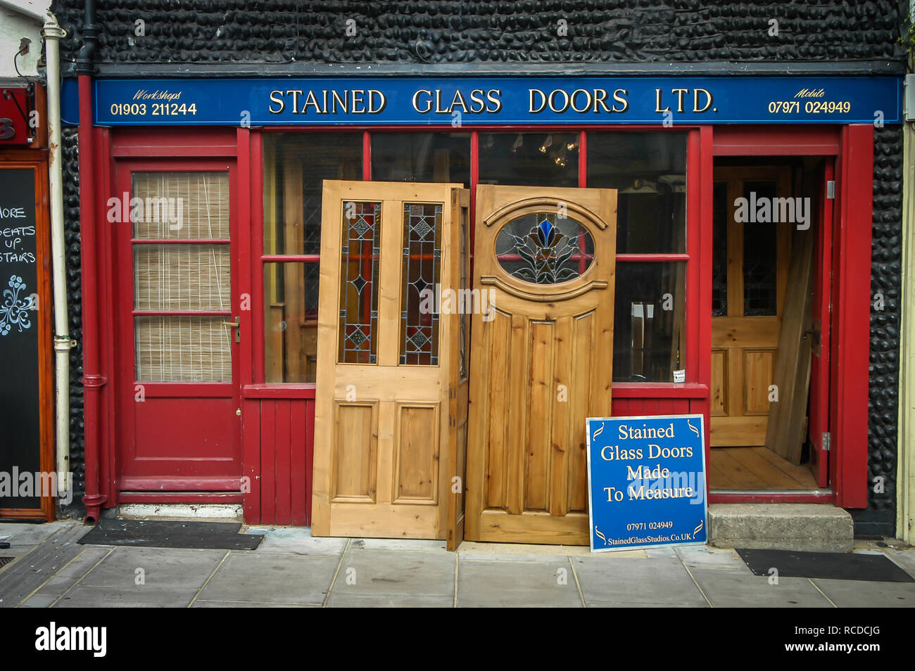 Doors and Windows displayed and on sale outside a shop front in