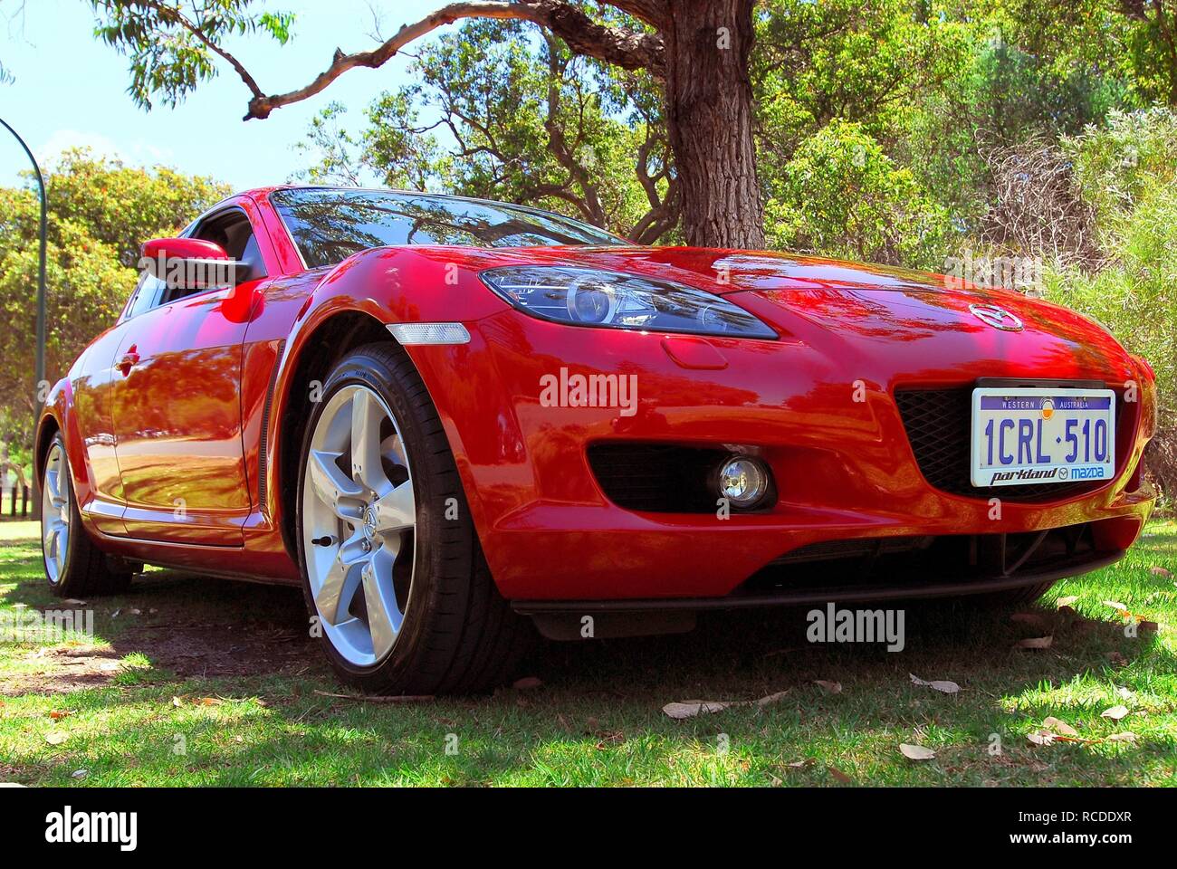 Red Mazda RX8 - Low 3/4 Frontal Image - In a Park, Nedlands, Perth, Western Australia Stock Photo