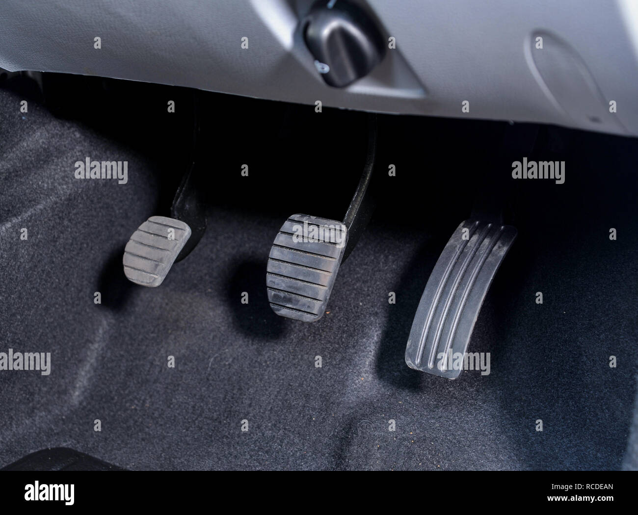 Manual car peddles, clutch, brake, accelerator, on a 2013 Dacia Logan MCV budget estate car Stock Photo