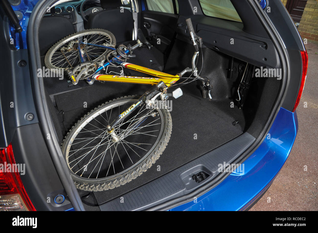 Mountain bike in the back of a 2013 Dacia Logan MCV budget estate car Stock Photo