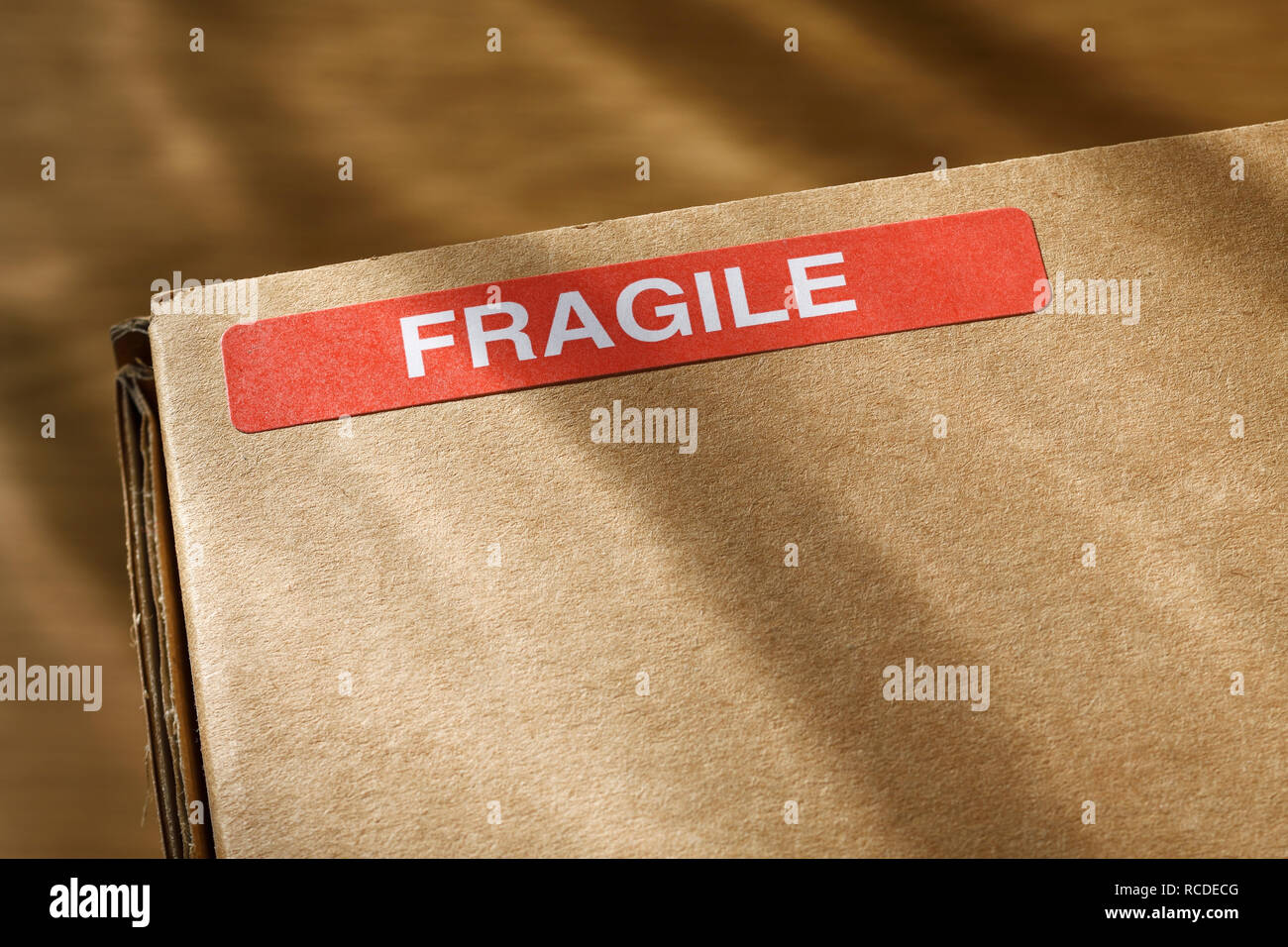 A Fragile sticker on a wcardboard box Stock Photo