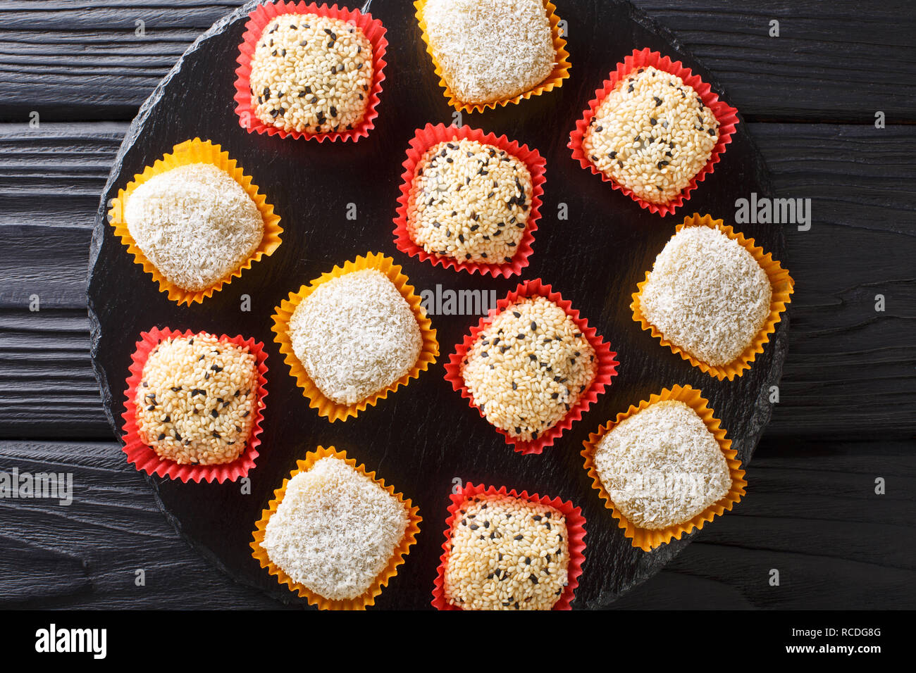 Japanese healthy rice dessert mochi daifuku with anko and sesame seeds closeup on the table