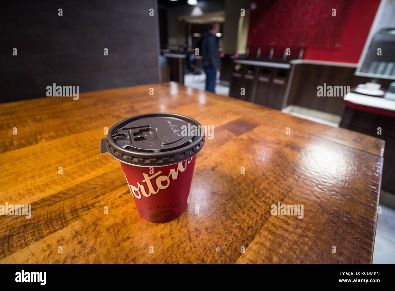 MONTREAL, CANADA - NOVEMBER 9, 2018: Close up on a cardboard coffee cup with Tim Hortons logo in one of their restaurants in Montreal, Quebec. Tim Hor Stock Photo