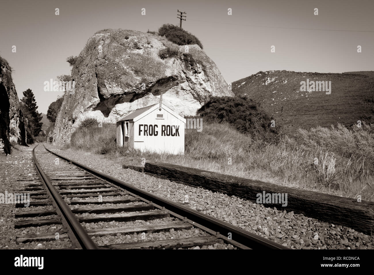 Old style image railway lines through gorge, between large rock outcrops past old disused Frog Rock Station in Waipara Valley north Canterbury New Zea Stock Photo