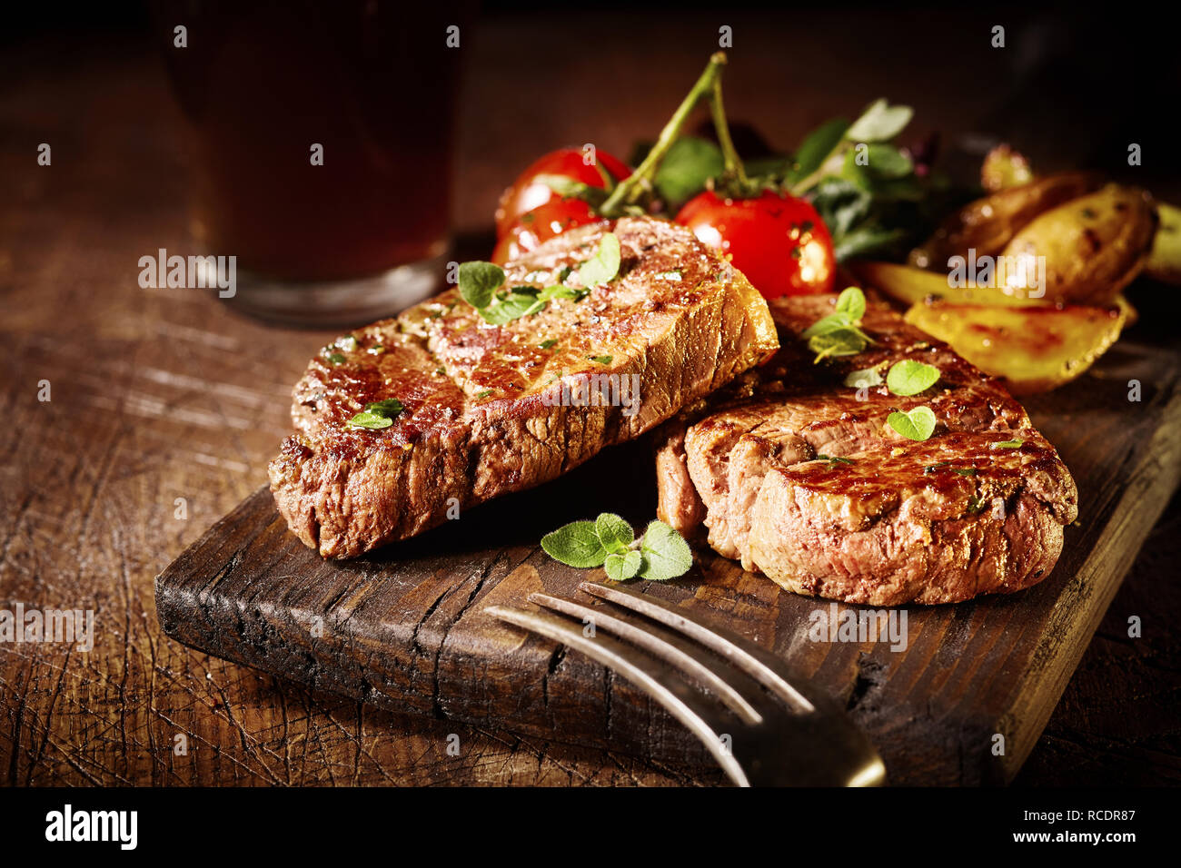 Thick tender roasted or grilled beef fillet medallions served on an old