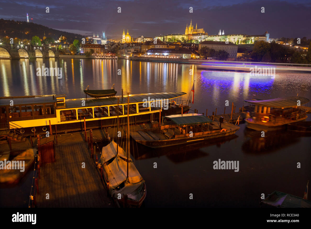 Prague - Charles bridge, castle and cathedral with the little harbor at dusk. Stock Photo