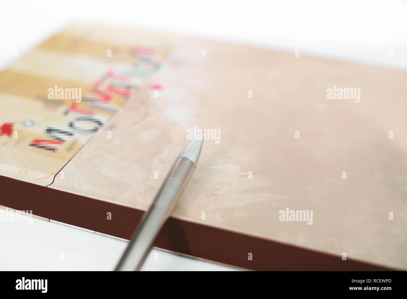 Picture of closed diary with pen. Isolated on the white background. Stock Photo