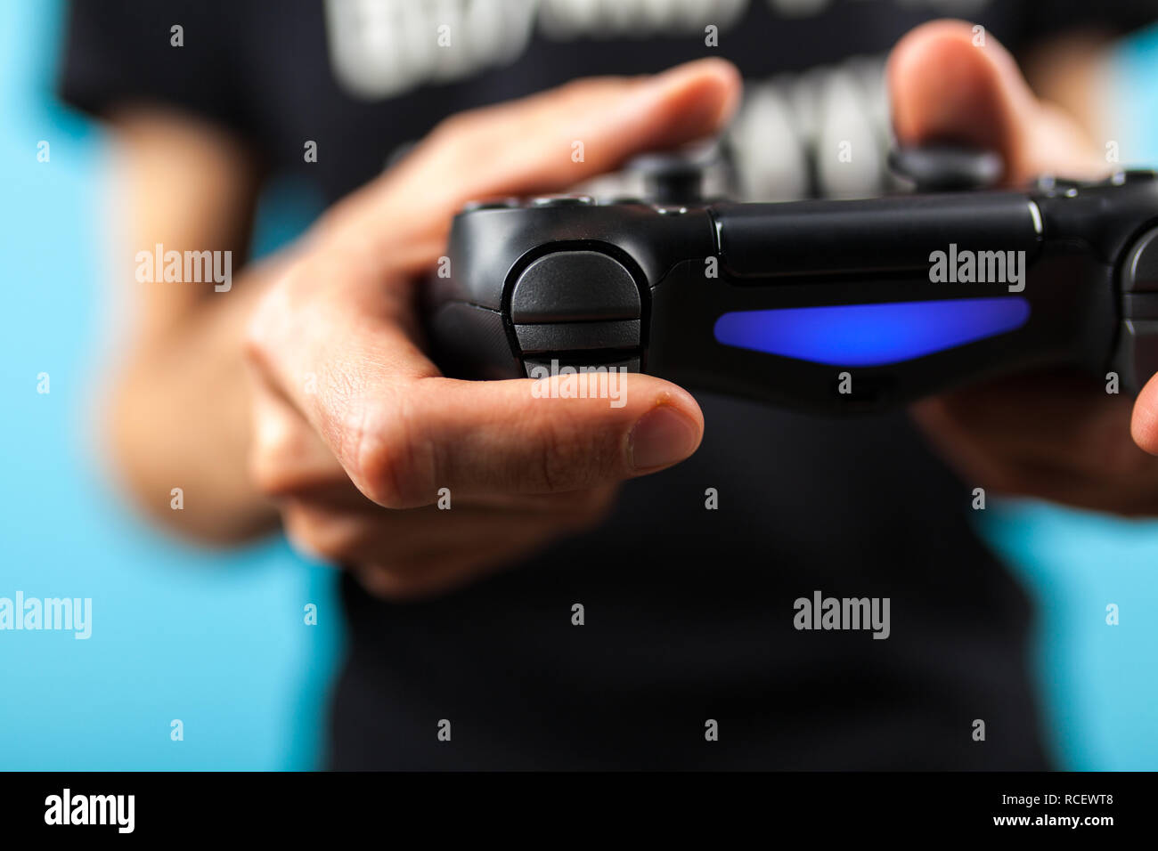 Male hands holding a gaming console controller Stock Photo - Alamy
