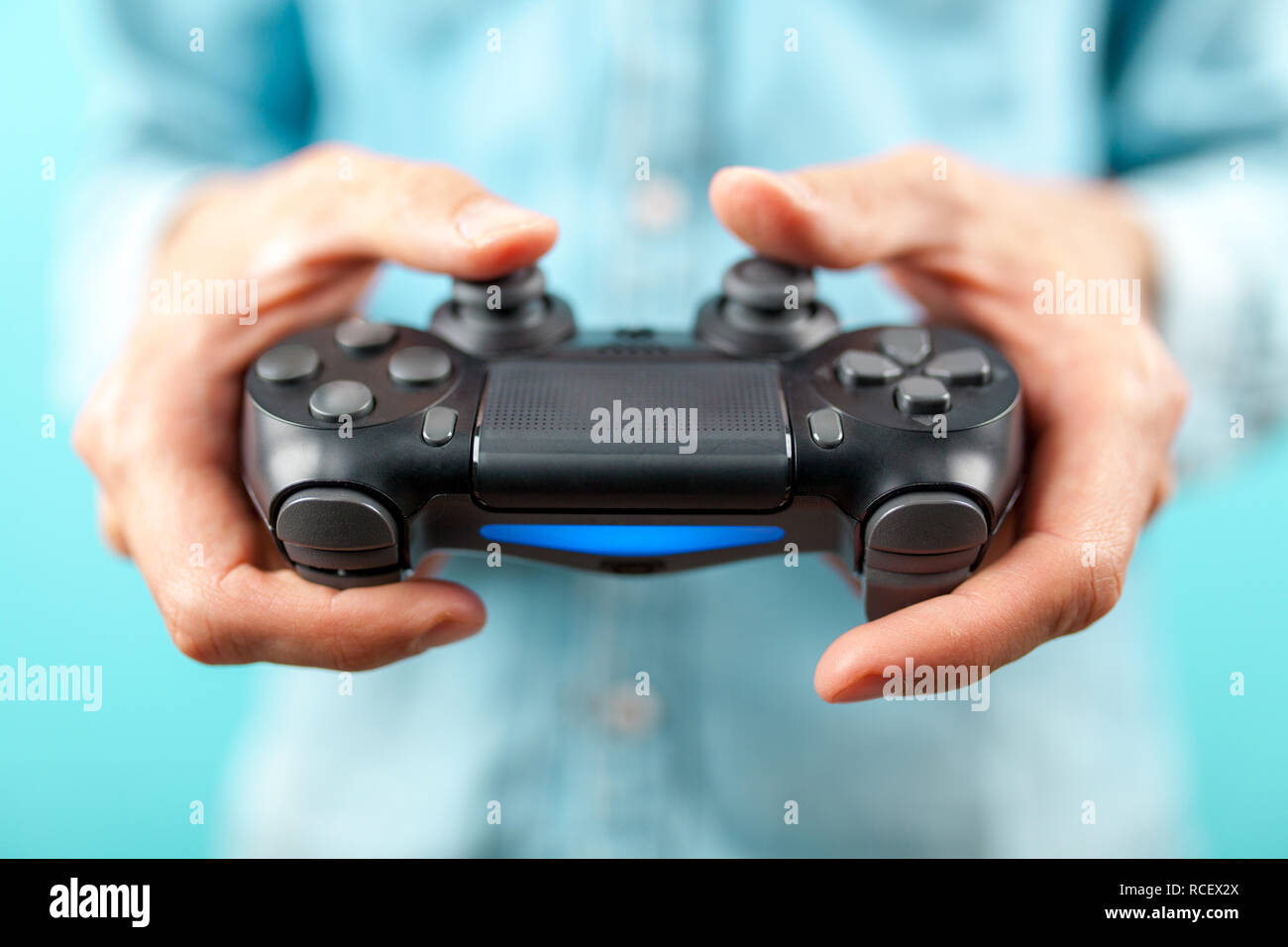 Male hands holding a gaming console controller Stock Photo Alamy