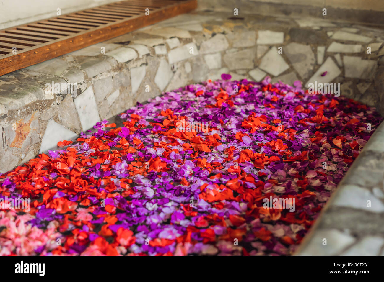 Bath with petals of tropical colors and aroma oils Stock Photo Alamy