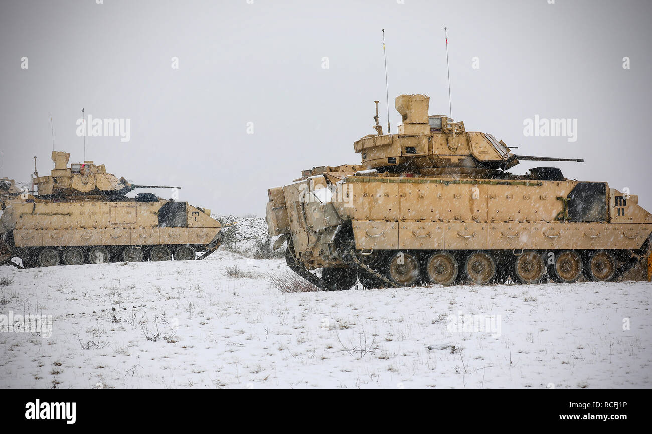 U.S. Army Bradley Fighting Vehicle crews assigned to the 91st Brigade Engineer Battalion, 1st Armored Brigade Combat Team, 1st Cavalry Division move into position at the firing range at Camp Aachen in Grafenwoehr, Germany Jan. 12, 2019. 91st BEB and 1-1 CD Soldiers are completing their rotation for Atlantic Resolve in Europe by completing live fire exercises and gunnery tables.  (U.S. Army National Guard photo by Sgt. 1st Class Ron Lee, 382nd Public Affairs Detachment, 1ABCT, 1CD released) Stock Photo