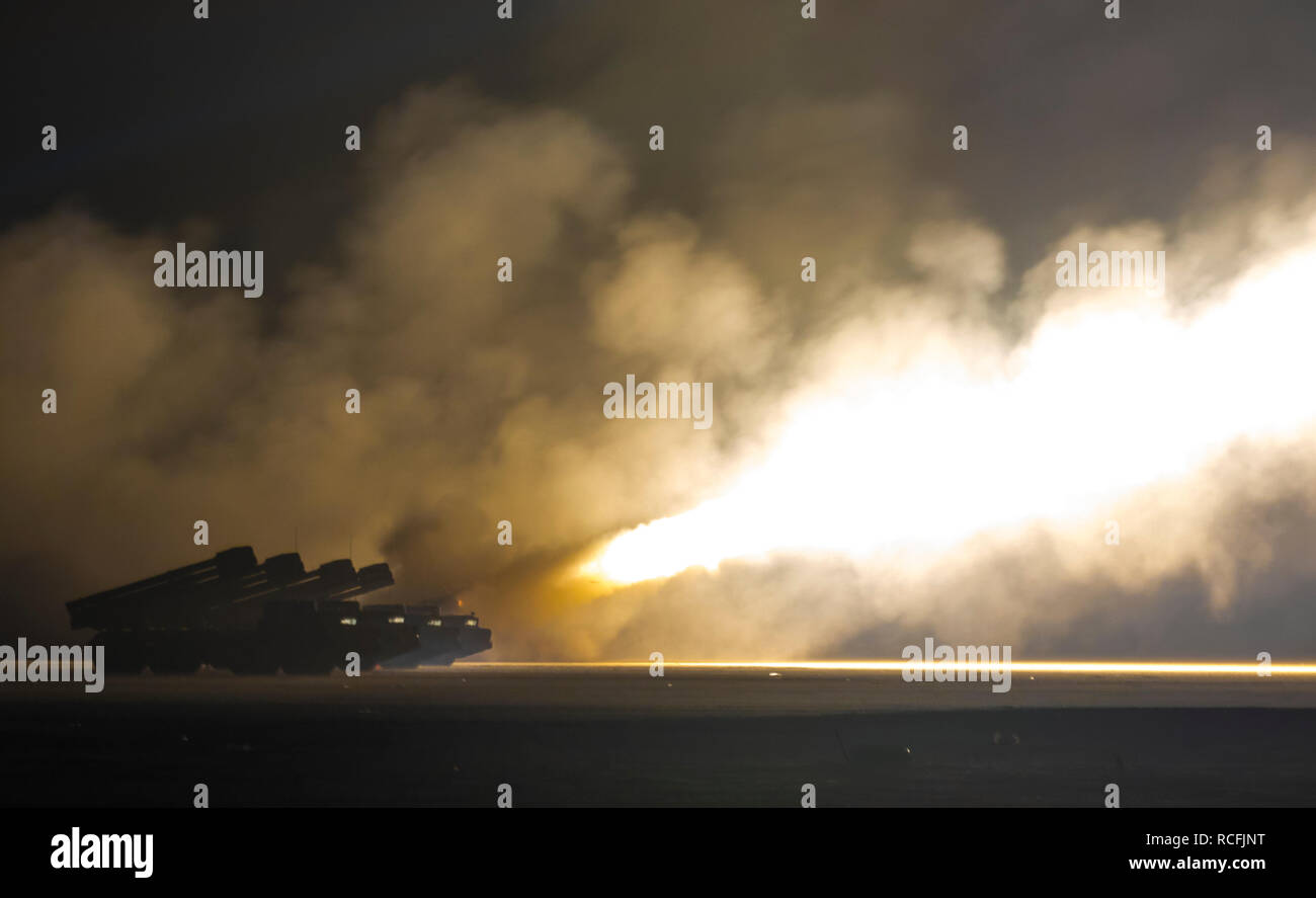 U.S. Army Soldiers assigned to the 65th Field Artillery Brigade, and soldiers from the Kuwait Land Forces fire their High Mobility Artillery Rocket Systems (U.S.) and BM-30 Smerch rocket systems (Kuwait) during a joint live-fire exercise, Jan. 8, 2019, near Camp Buehring, Kuwait. The U.S. and Kuwaiti forces train together frequently to maintain a high level of combat readiness and to maintain effective communication between the two forces. (U.S. Army Photo by Sgt. James Lefty Larimer) Stock Photo