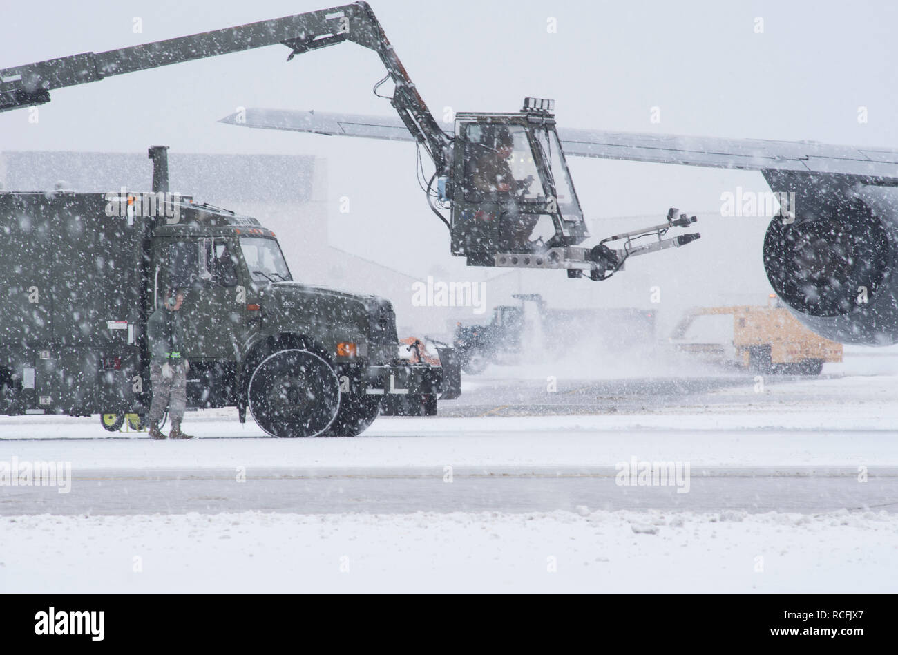 Airmen from the 108th Maintenance Group prepare to de-ice a KC-135R Stratotanker on the flightline at Joint Base McGuire-Dix-Lakehurst, N.J., Jan. 13, 2019. Snow removal from the flightline and deicing of aircraft are very important for maintaining the unit's aircraft and mission readiness. (U.S. Air National Guard photo by Senior Julia Santiago) Stock Photo