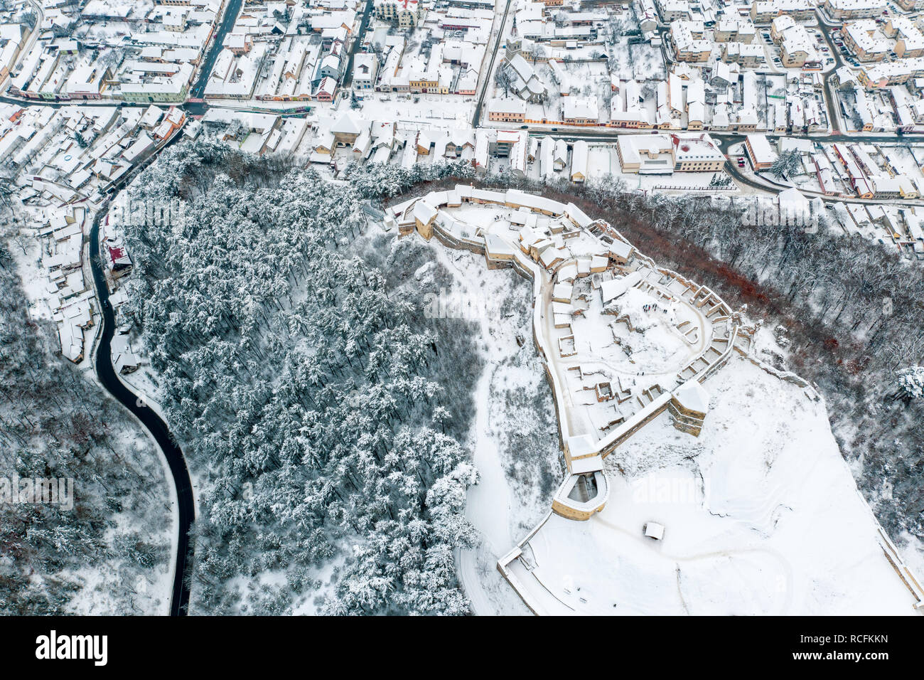 Rasnov Fortress and Rasnov City in winter time covered in snow Stock Photo