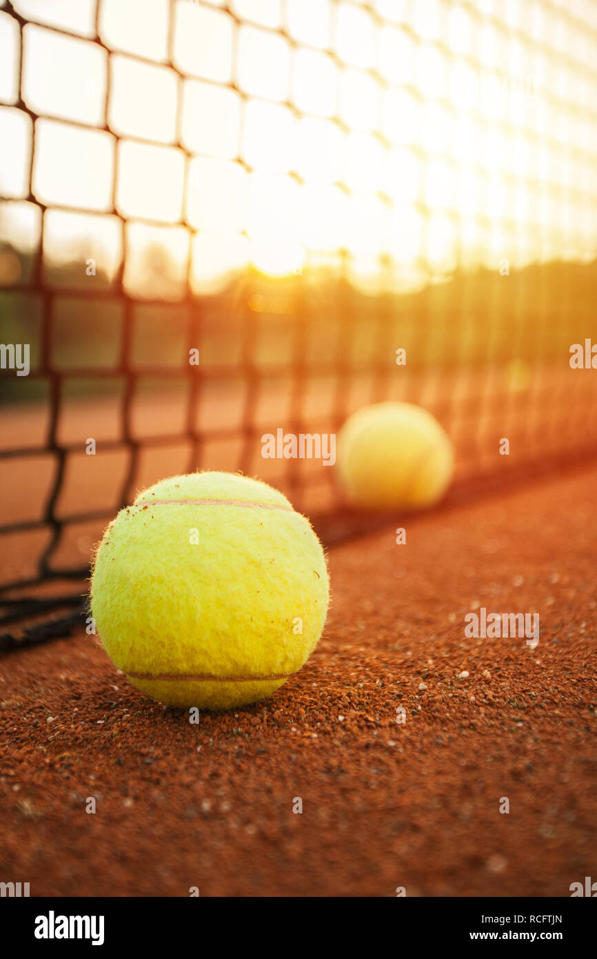 Tennis balls in front of tennis court Stock Photo Alamy