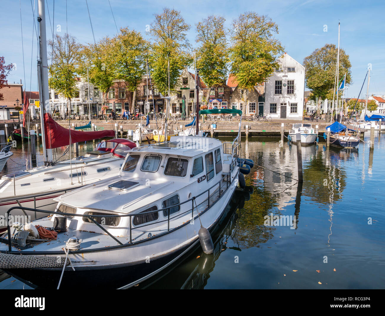 Boats moored in marina of small harbour in old town of Middelharnis on Goeree-Overflakkee, Zuid-Holland, Netherlands Stock Photo