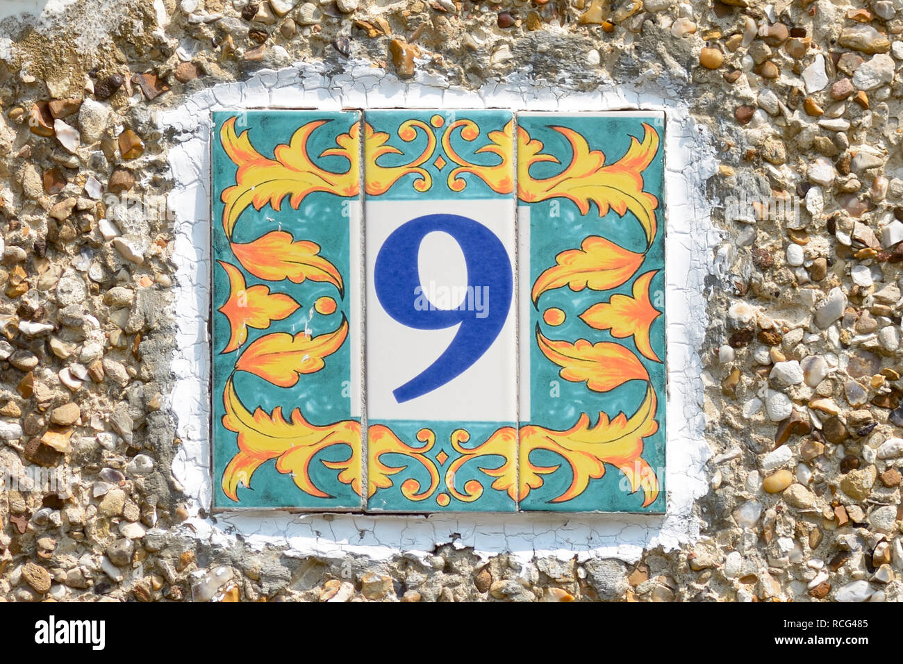 House number 9 sign - tile with colourful surround Stock Photo
