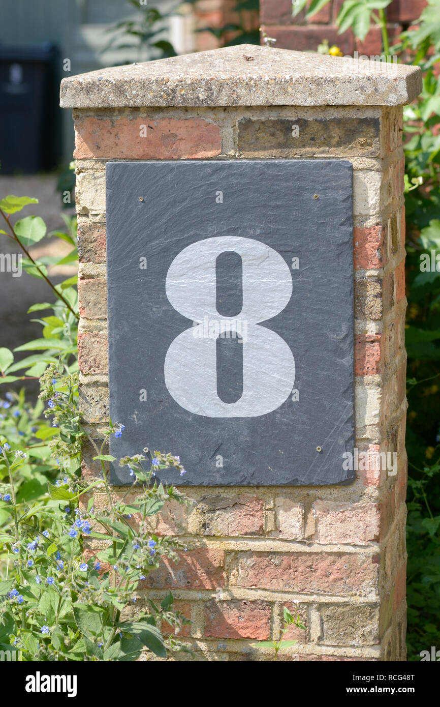 House number 8 sign on wall Stock Photo