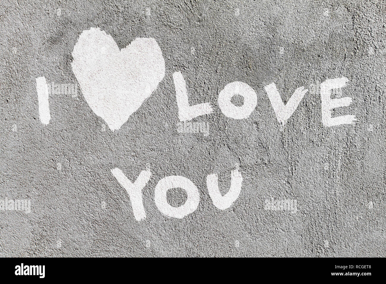 inscription I love you with abstract heart on the concrete wall Stock