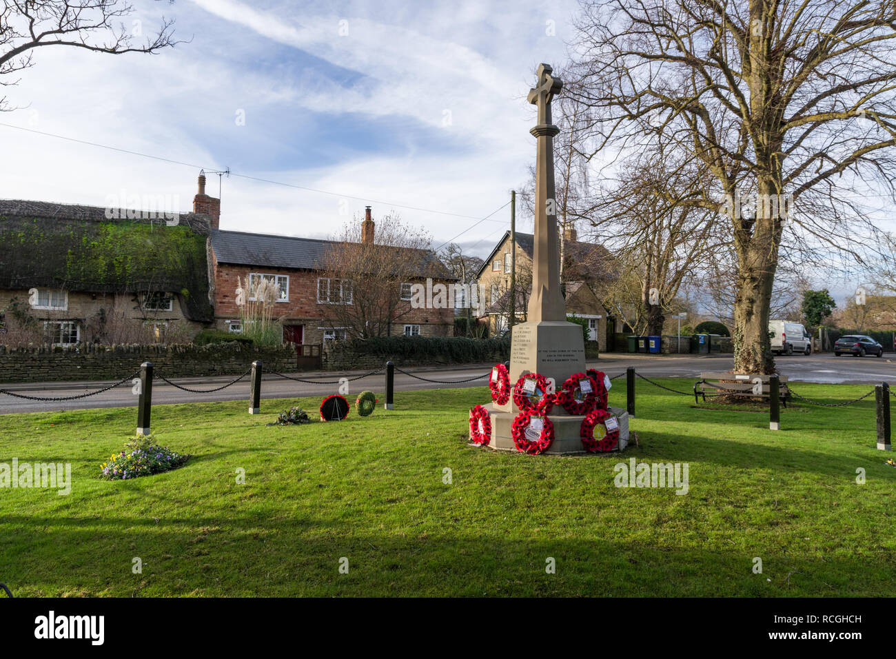 Memorial Green in the village of Roade, Northamptonshire, UK; with a WW1 war memorial and poppy wreaths. Stock Photo