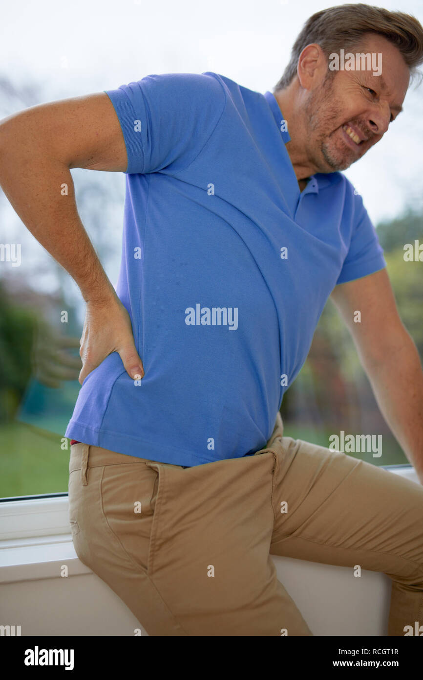 Man with back ache Stock Photo