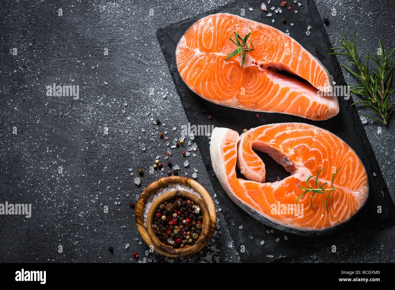 Salmon fish steak with spices on black Stock Photo - Alamy