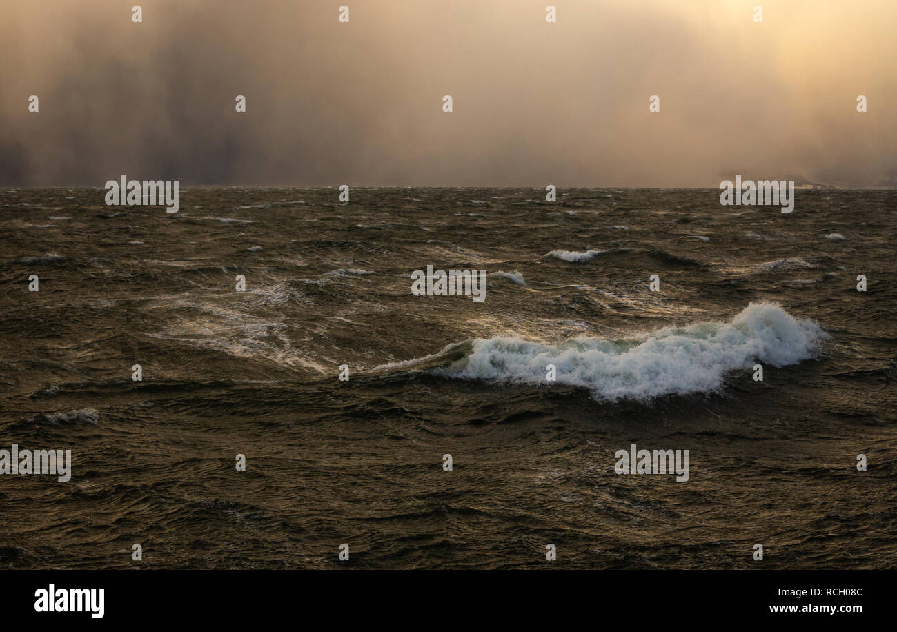 Winter stormy weather and incoming blizzard over Trondheimsfjorden near Trondheim, Norway. Stock Photo