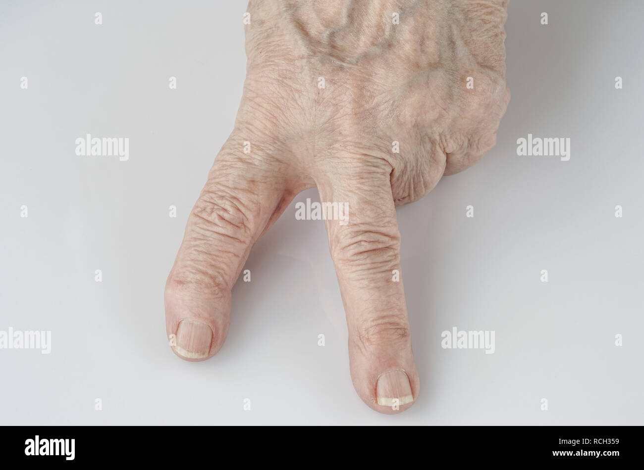 victory sign by fingers of a wrinkled hand on white Stock Photo Alamy