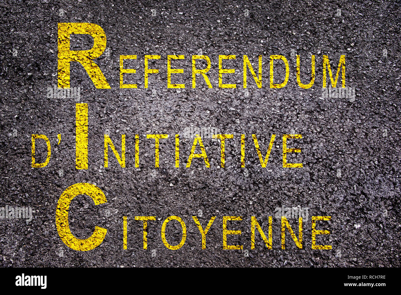 Word RIC (meaning referendum at citizen's initiative) on asphalt background Stock Photo