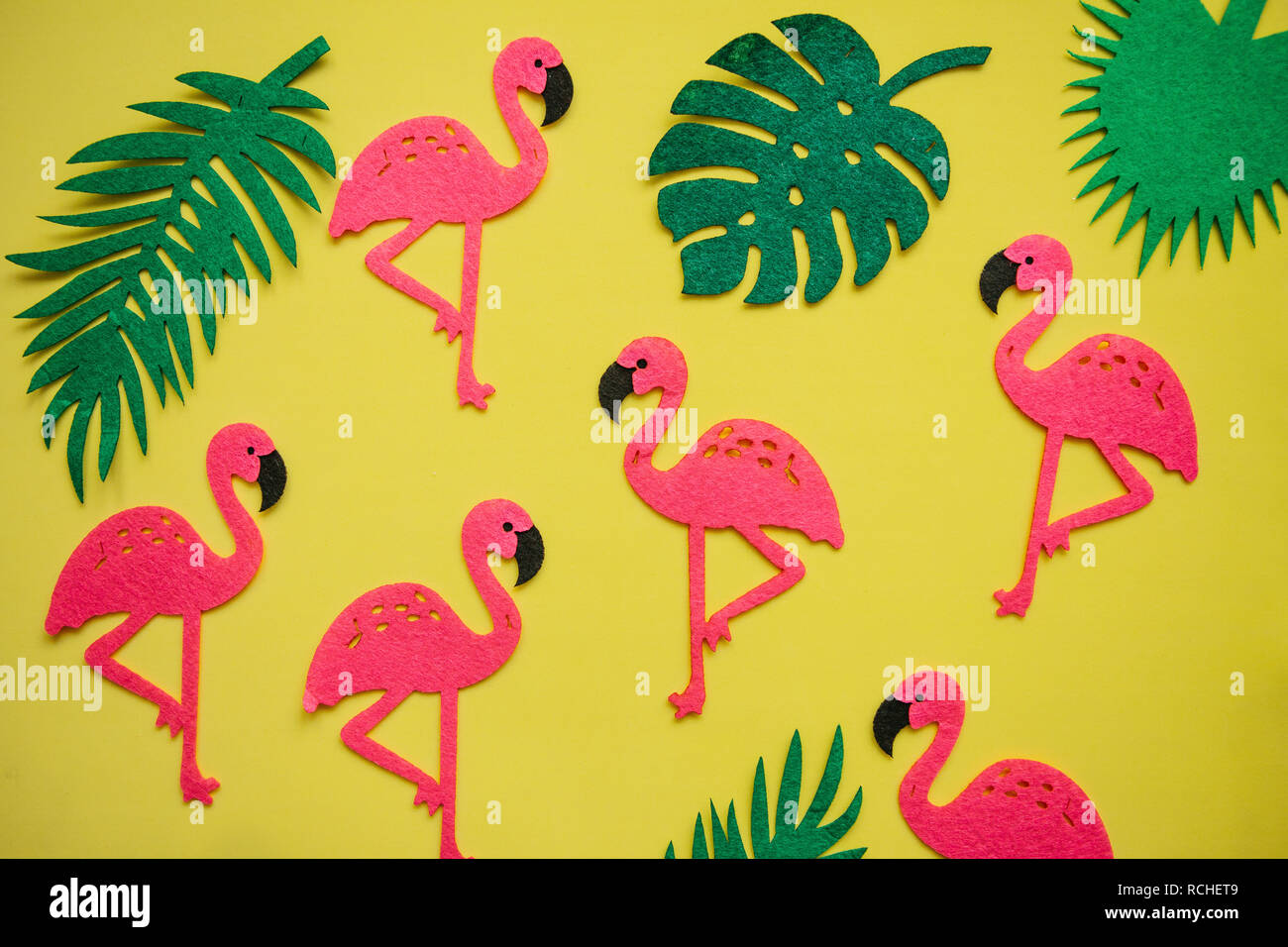 Tropical summer bright background with many plant leaves and flamingos ...