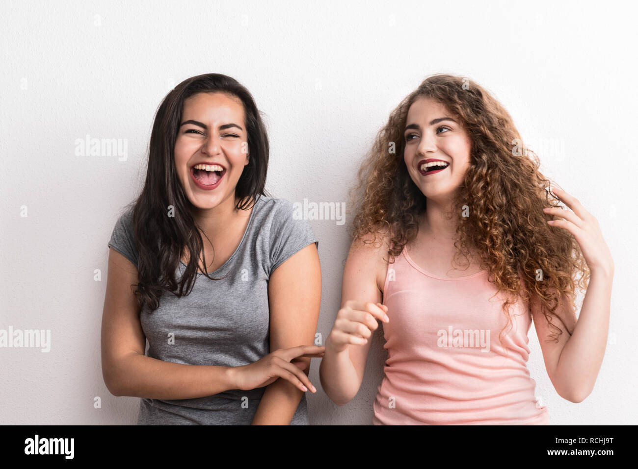 Young beautiful women in a studio, laughing. Stock Photo