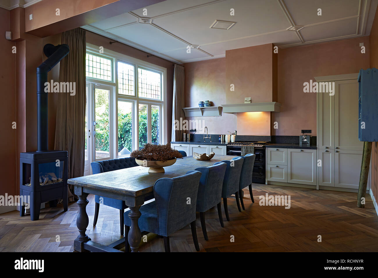 Classic Designer Kitchen With Long Wooden Dining Table In The Middle Stock Photo Alamy