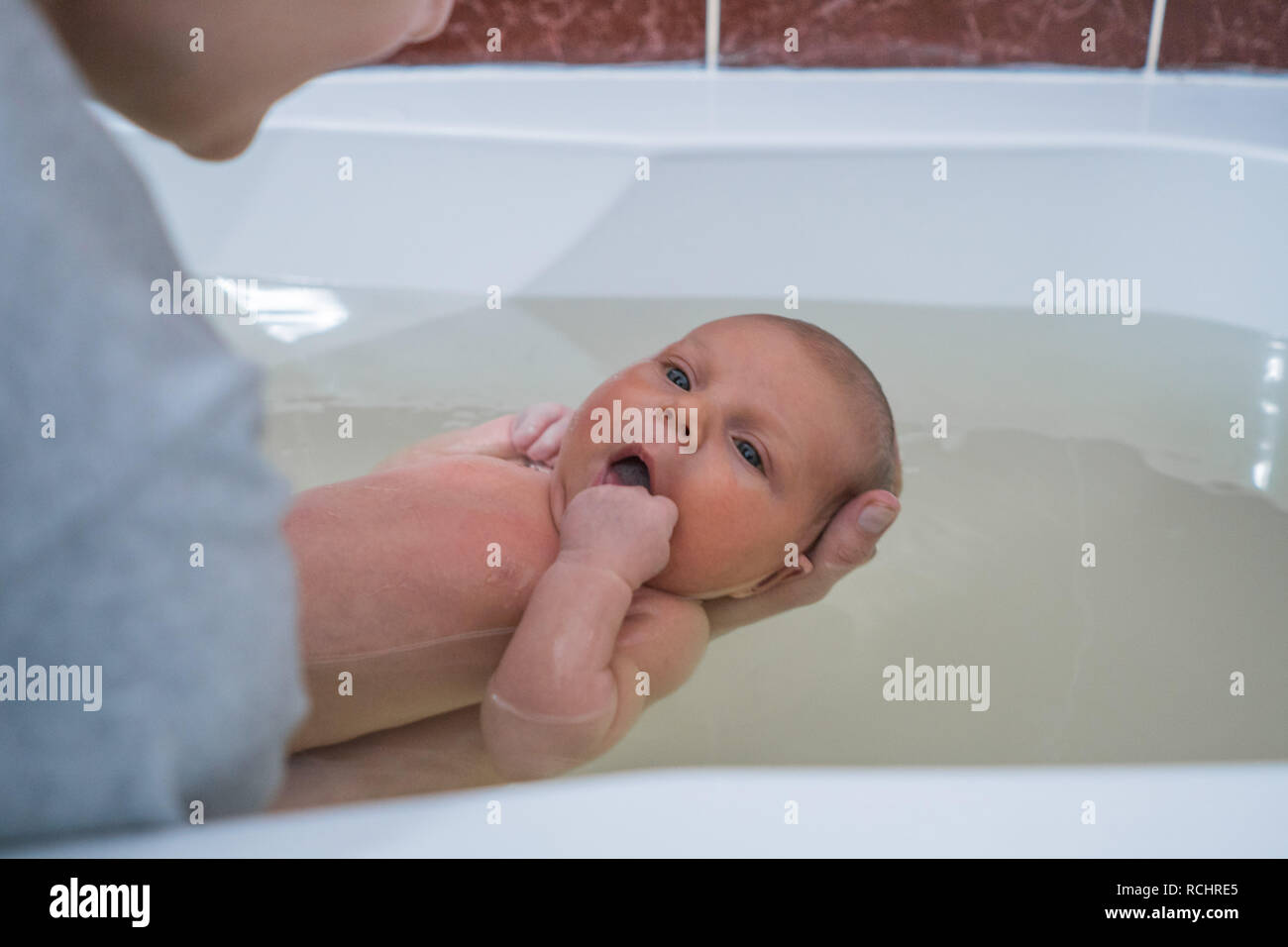 Children's health therapy for the baby. Bathing baby in a warm bath