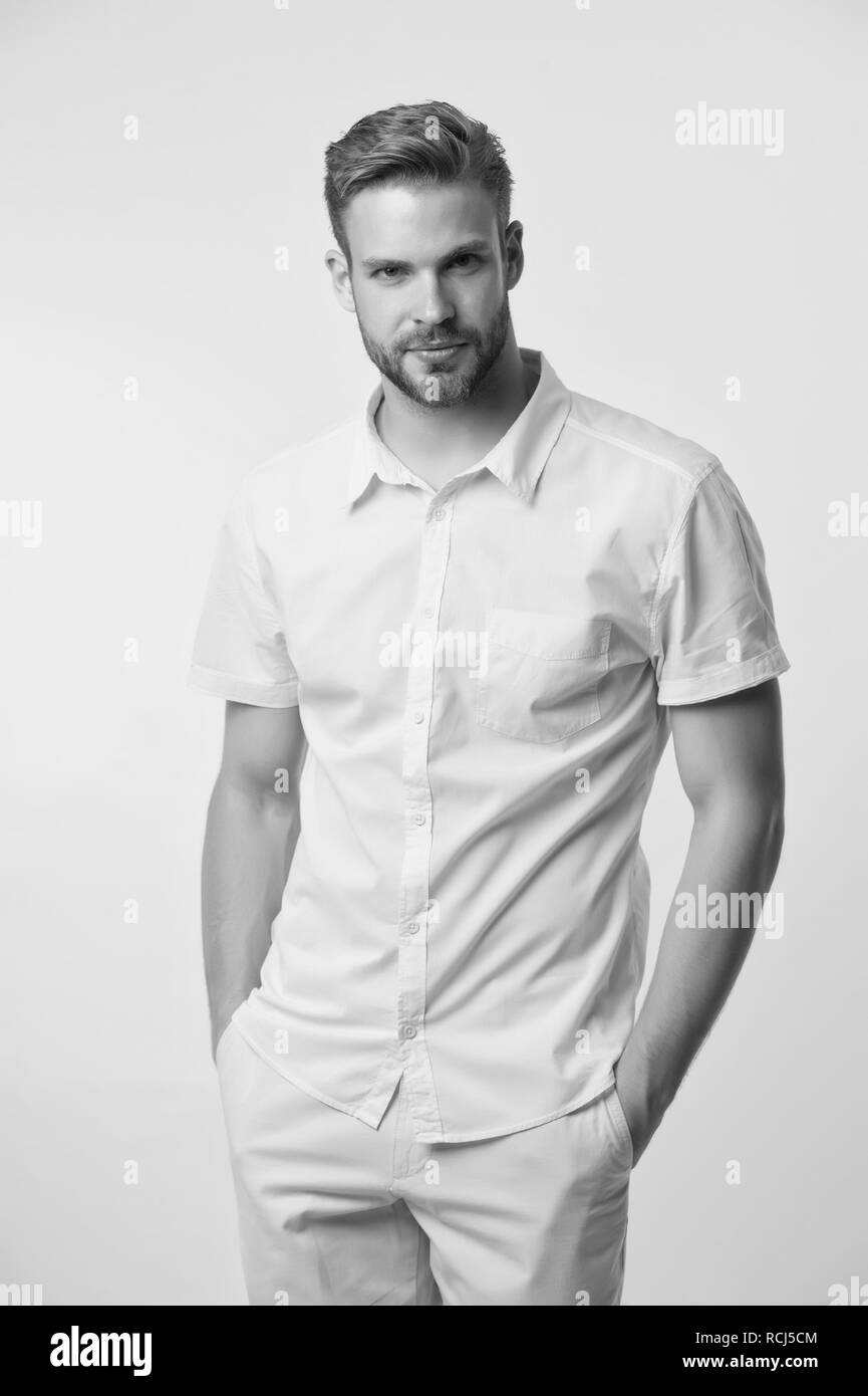 Man on calm face posing confidently with hands in pockets. Man look attractive in casual linen shirt. Guy fashion model wear casual shirt. Feel comfortable in simple outfit. Casual comfortable outfit ...