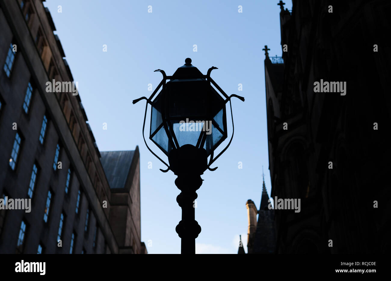 An old fashioned cast iron streetlamp between The Town Hall and Town Hall Extension on Mount Street, Manchester Stock Photo
