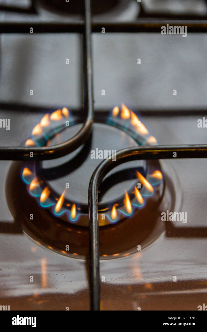 Gas stove with burning orange and blue fire on it Stock Photo Alamy