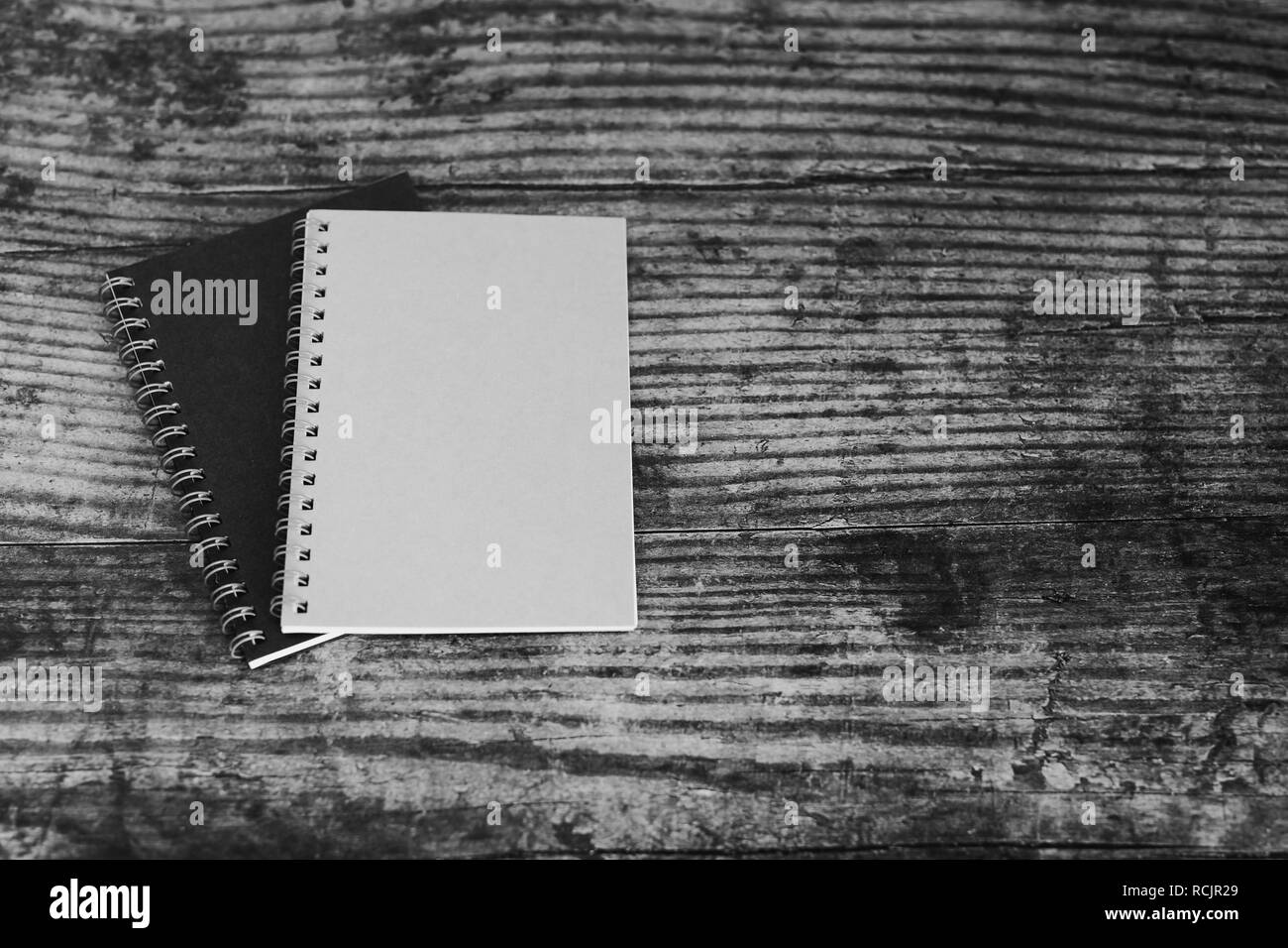 Minimalist Desk Setting Flatlay With Notepads On Dark Wooden Surface In Black And White Stock Photo Alamy