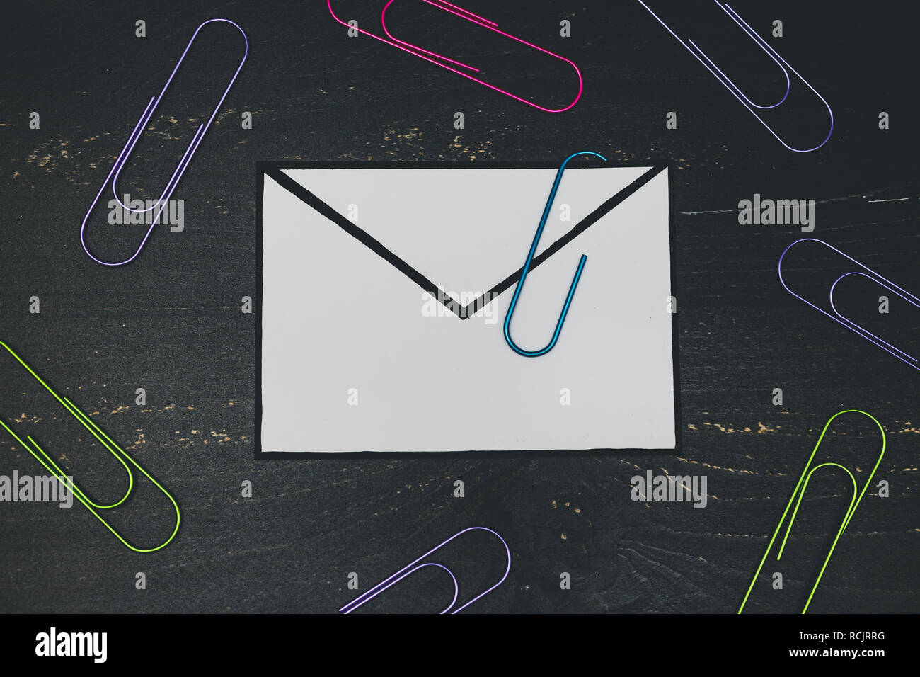 funny metaphor of inbox with email envelop and attachment clip on real ...