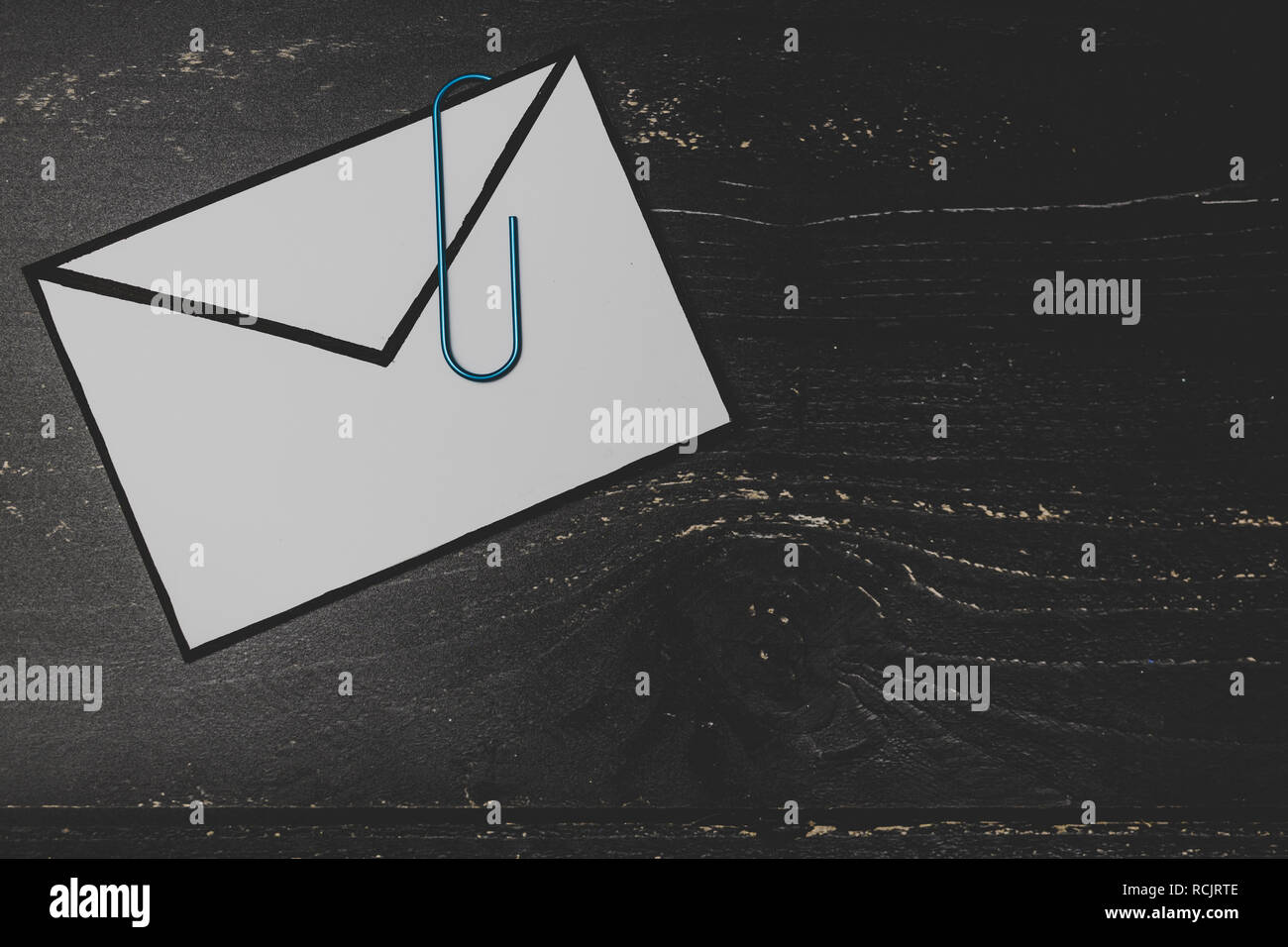 funny metaphor of inbox with email envelop and attachment clip on real ...