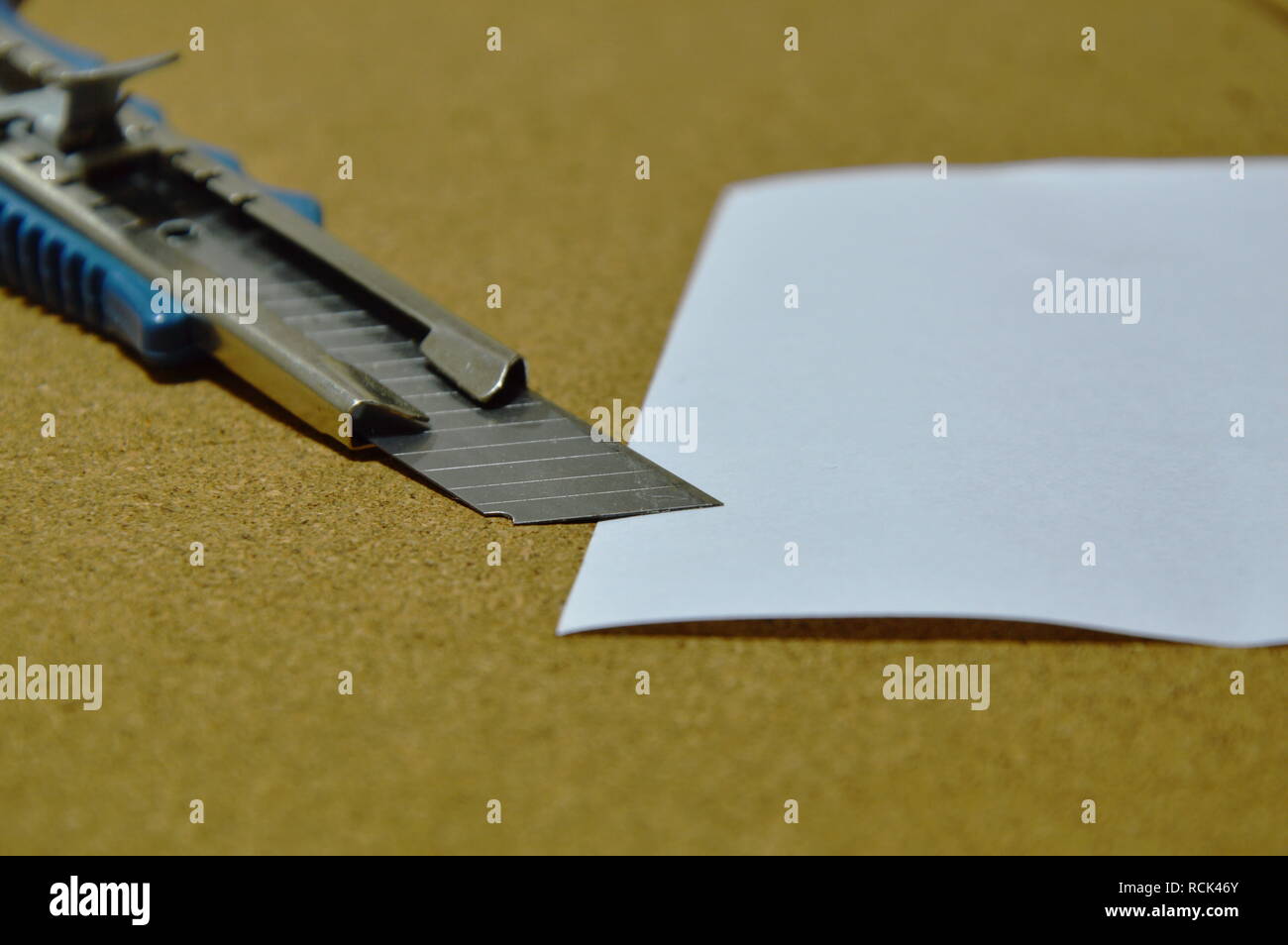cutter and paper on wooden notice board Stock Photo - Alamy