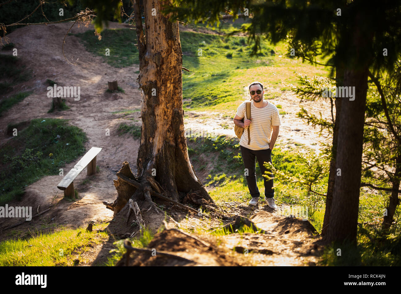 Man using hiking with backpack outdoors in woods Stock Photo