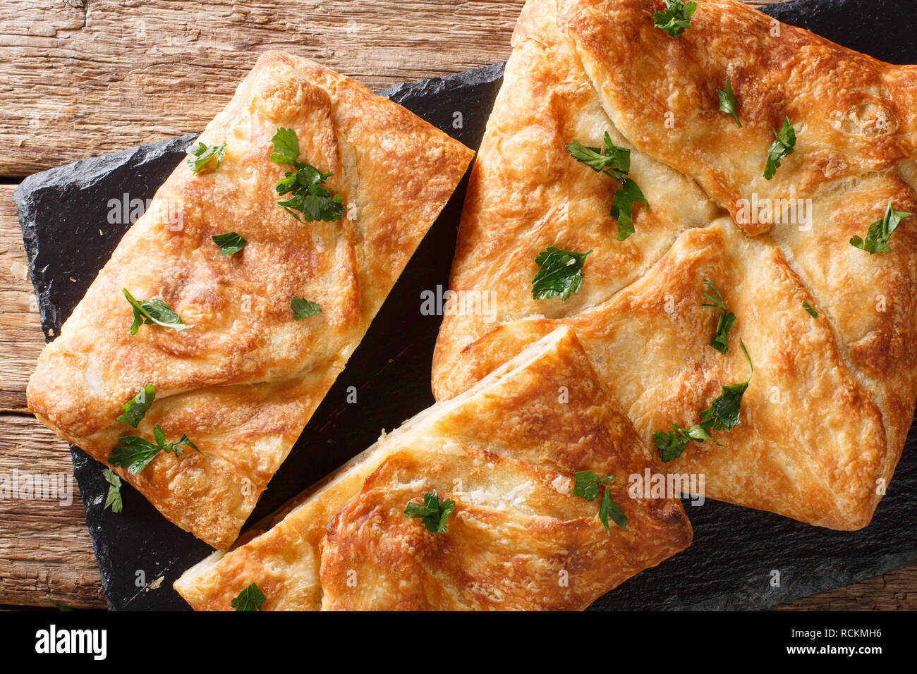 Khachapuri is a traditional Georgian dish of cheese-filled bread. The filling contains cheese sulguni, eggs and other ingredients horizontal top view  Stock Photo
