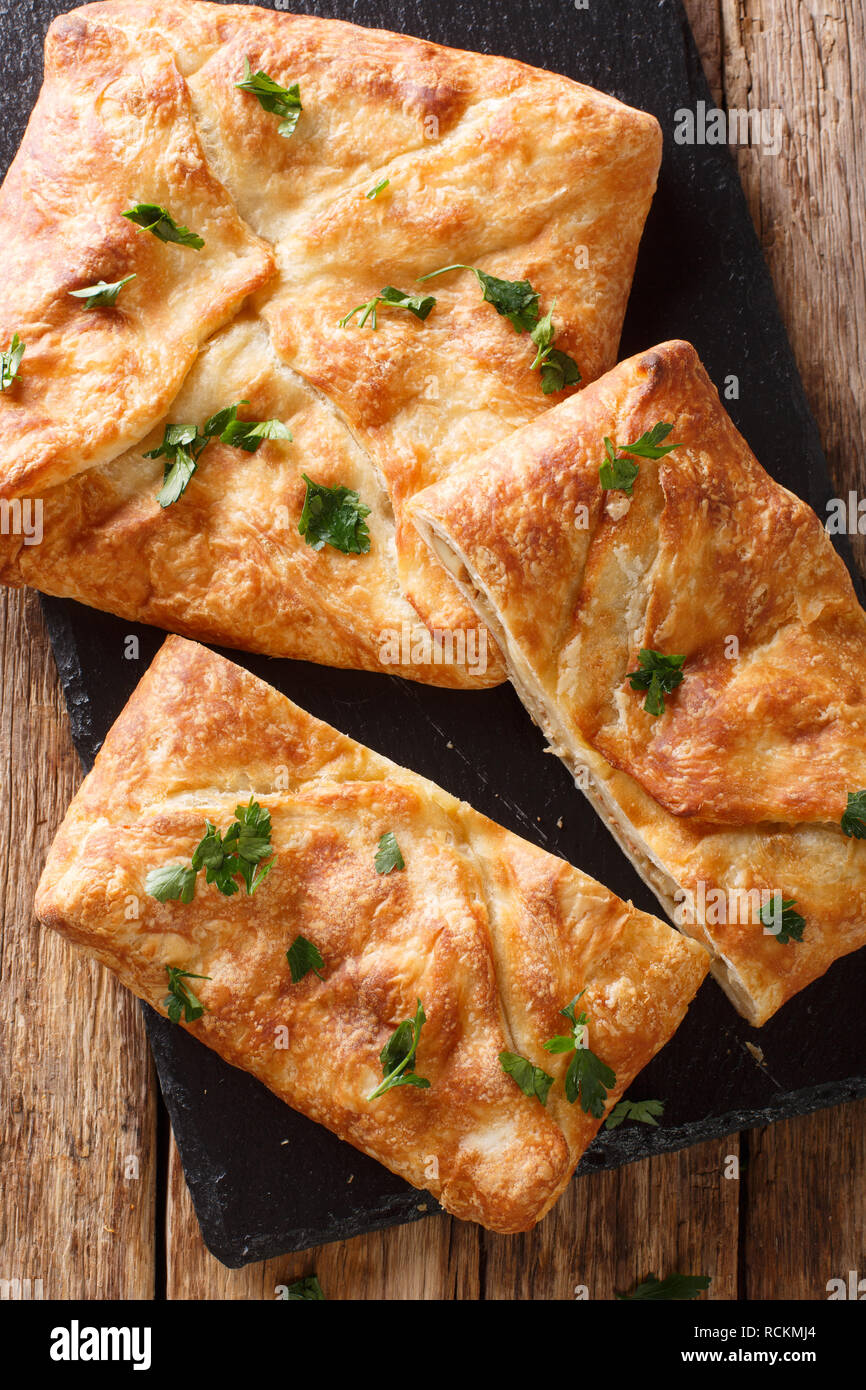 Khachapuri is a traditional Georgian dish of cheese-filled bread. The filling contains cheese sulguni, eggs and other ingredients Vertical top view fr Stock Photo